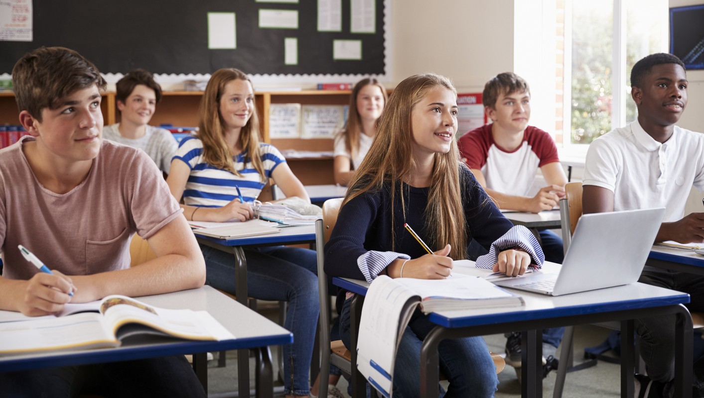 students listening to teacher in classroom